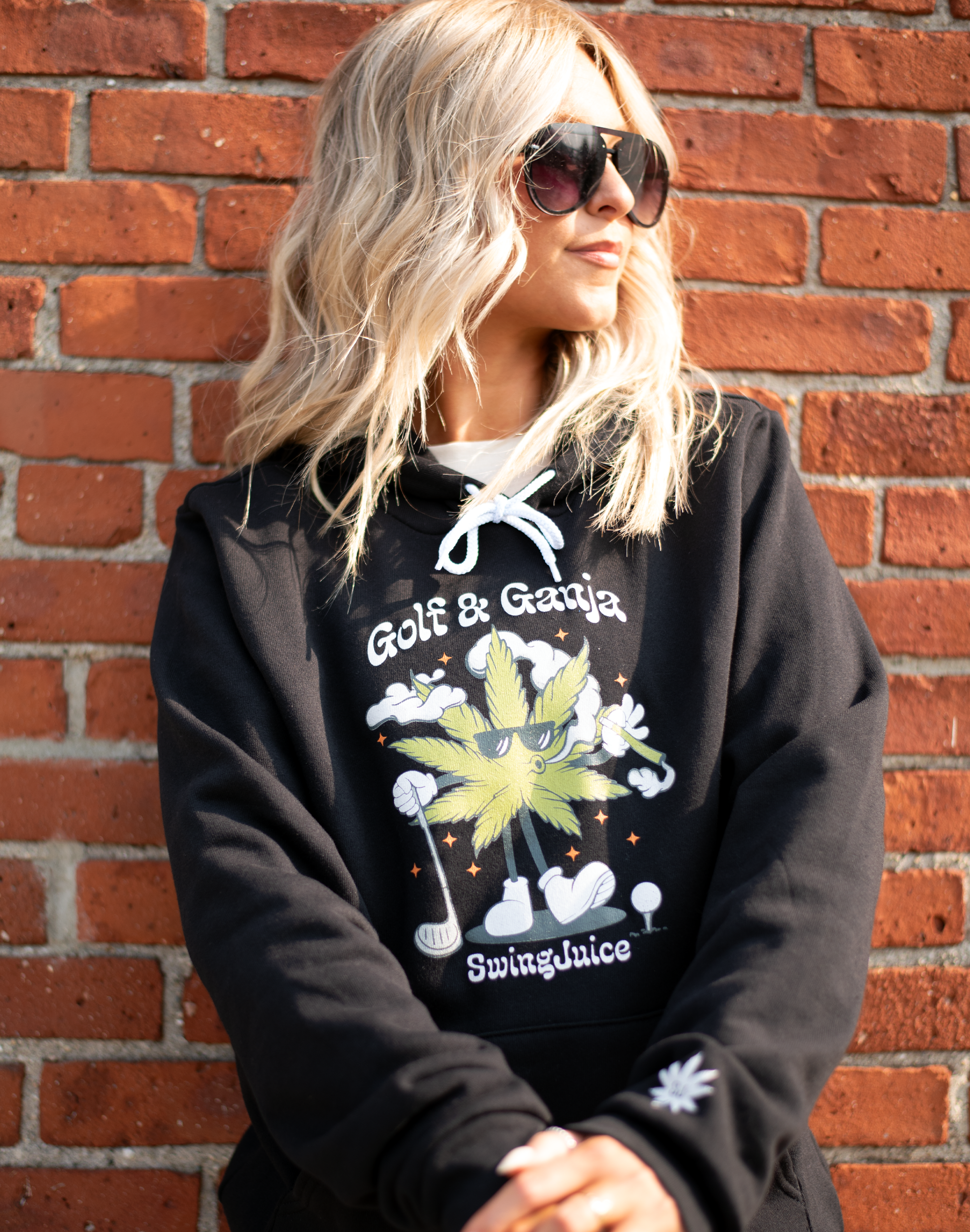https://www.gun-ammo.com/wp-content/uploads/A0004/gunsphoto-2/mancaveandapparel-1/01-swingjuice-long-sleeve-unisex-hoodie-golf-ganja-black.png
